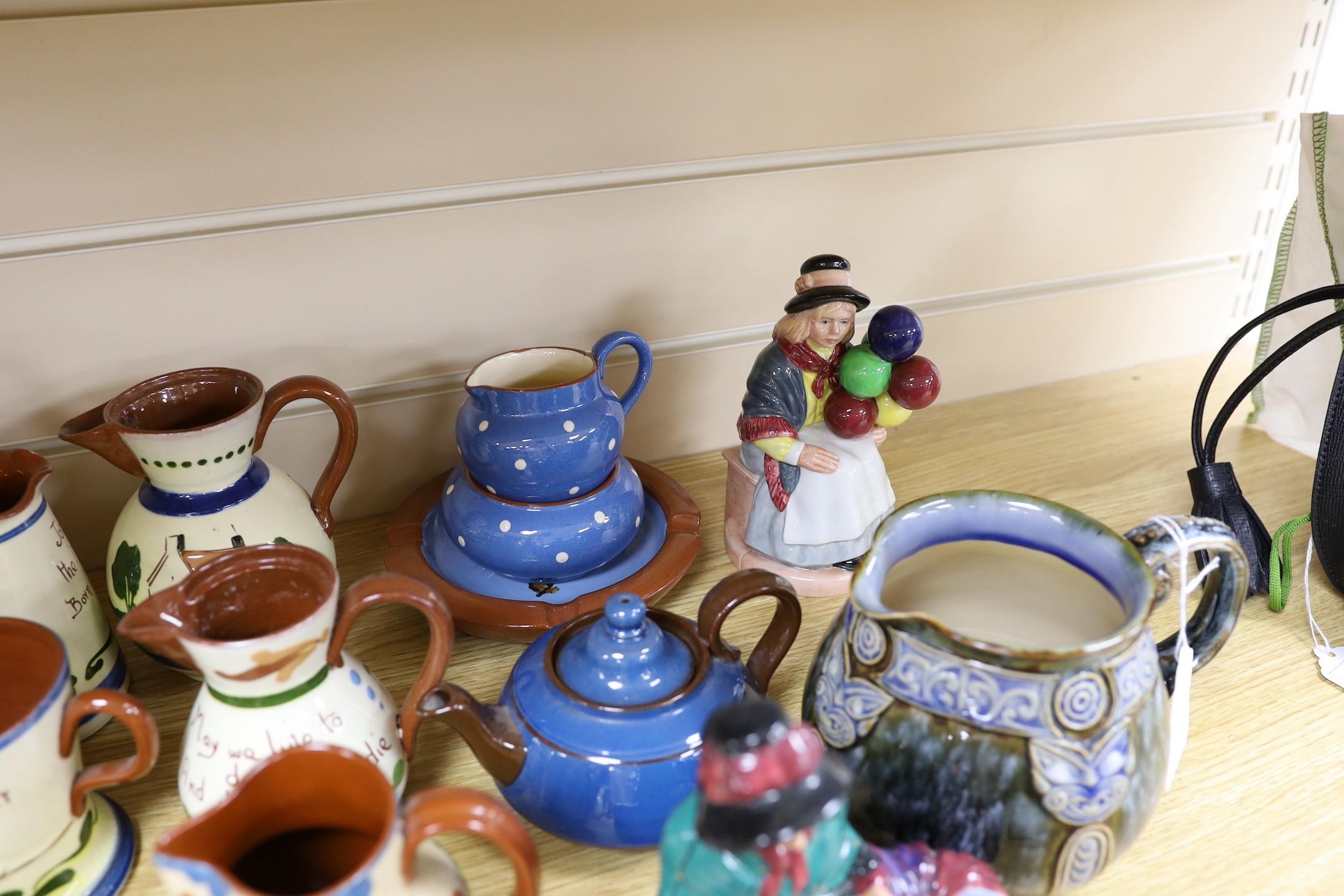 A collection of Doulton vessels and Torquay Mottoware